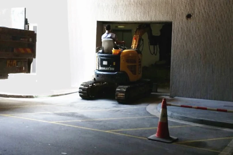 Excavator moved into the Library to clear the raised level